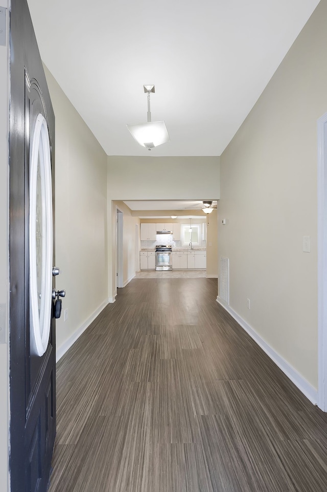 unfurnished living room with dark hardwood / wood-style floors