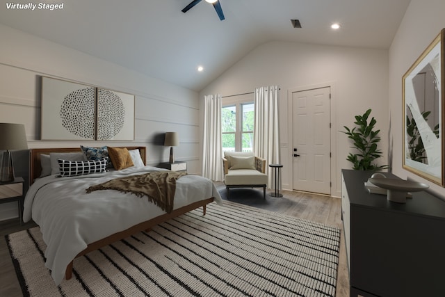 bedroom with ceiling fan, wood-type flooring, and vaulted ceiling