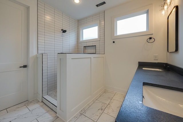 bathroom featuring vanity and tiled shower