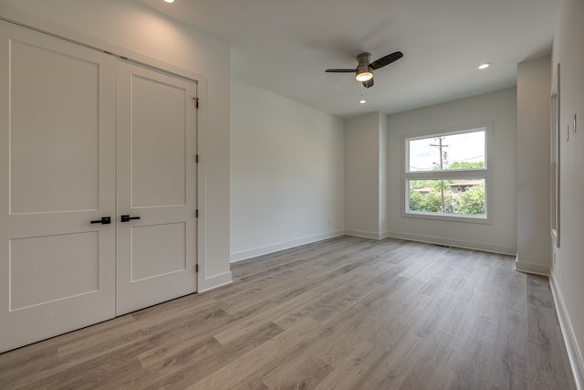 unfurnished bedroom with a closet, ceiling fan, and light hardwood / wood-style floors