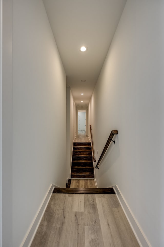 staircase featuring wood-type flooring