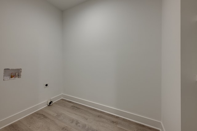 clothes washing area with light hardwood / wood-style floors, washer hookup, and electric dryer hookup