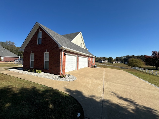 view of property exterior featuring a garage and a lawn