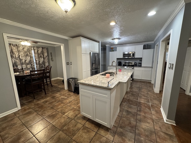 kitchen featuring ornamental molding, white cabinets, stainless steel appliances, and sink