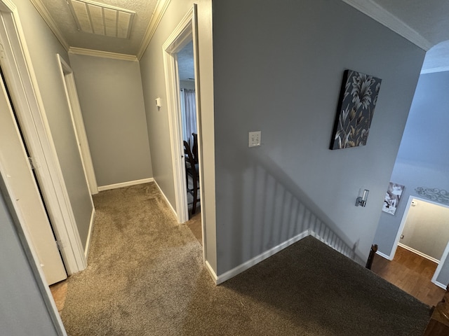 hall with crown molding and carpet flooring