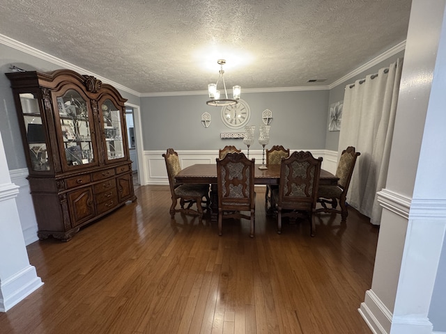 dining space with crown molding, a textured ceiling, a chandelier, and dark hardwood / wood-style flooring