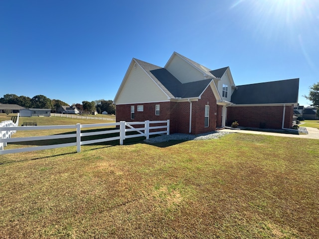 view of side of property with a lawn