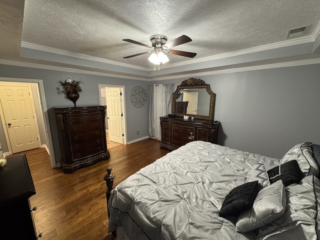 bedroom with crown molding, a textured ceiling, dark wood-type flooring, and ceiling fan