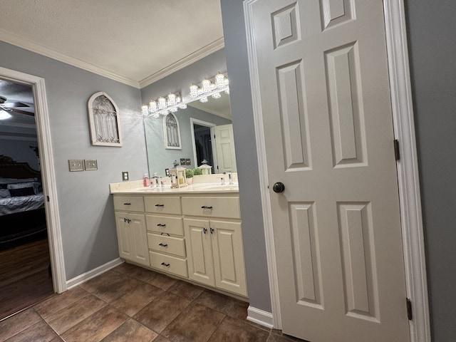 bathroom featuring vanity, crown molding, a textured ceiling, and ceiling fan