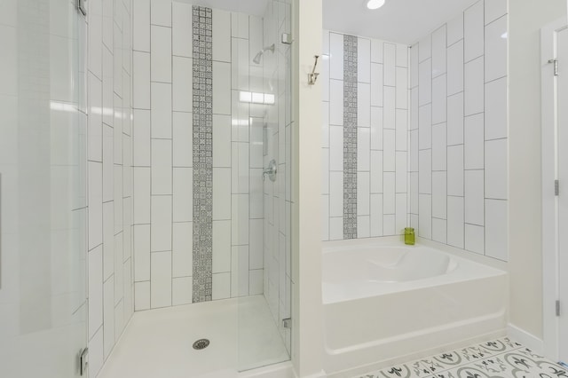 bathroom with plus walk in shower and tile patterned flooring