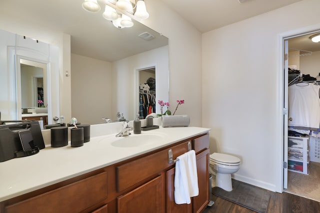 bathroom featuring vanity, toilet, and hardwood / wood-style floors