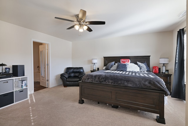 carpeted bedroom featuring ensuite bath and ceiling fan