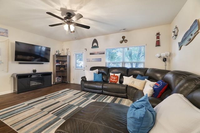 living room with ceiling fan and dark hardwood / wood-style floors