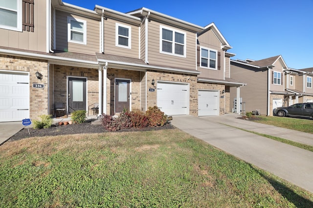 view of property featuring a front yard and a garage