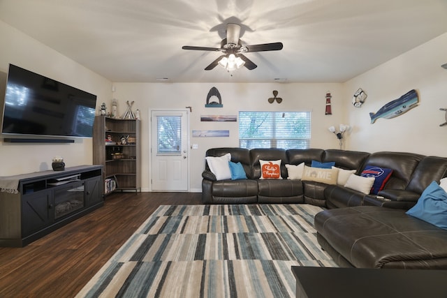 living room with dark wood-type flooring and ceiling fan