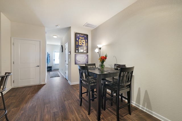 dining area featuring dark hardwood / wood-style floors