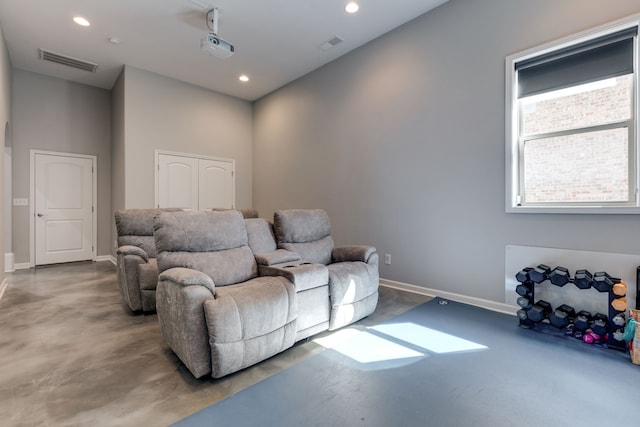 home theater room featuring concrete floors