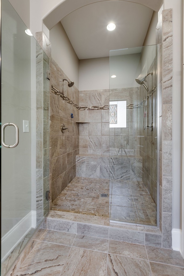 bathroom with a shower with door