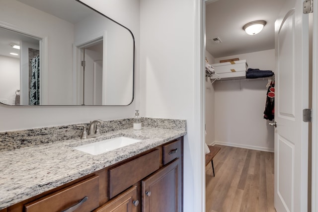 bathroom featuring vanity and hardwood / wood-style flooring