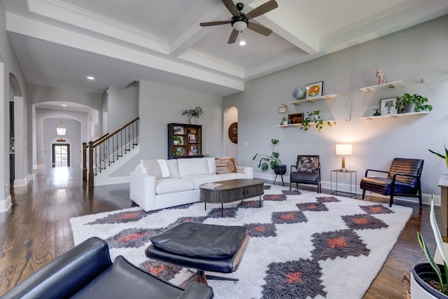 living room featuring ornamental molding, dark hardwood / wood-style floors, beam ceiling, and ceiling fan