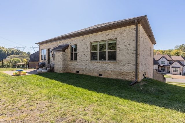 rear view of property featuring a lawn