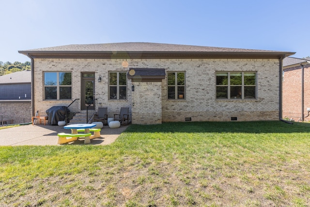 rear view of house with a yard and a patio area