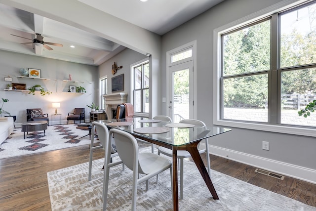 dining area with beam ceiling, dark wood-type flooring, and ceiling fan