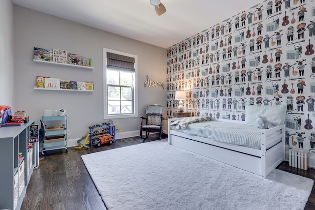 bedroom featuring ceiling fan and dark hardwood / wood-style flooring