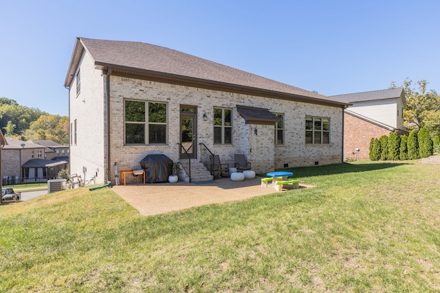 back of house with a patio area and a lawn