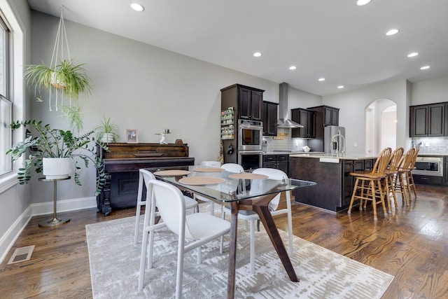 dining space with sink and dark hardwood / wood-style flooring