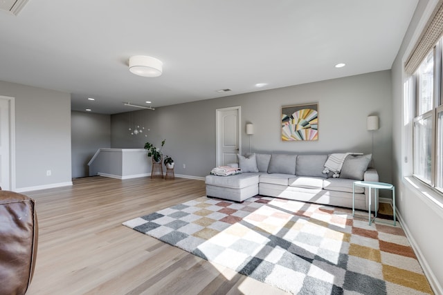 living room with light hardwood / wood-style flooring and plenty of natural light