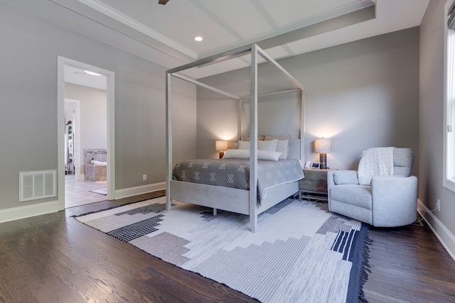 bedroom with ornamental molding, hardwood / wood-style floors, and ensuite bath