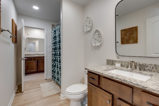 bathroom with vanity, hardwood / wood-style flooring, and toilet