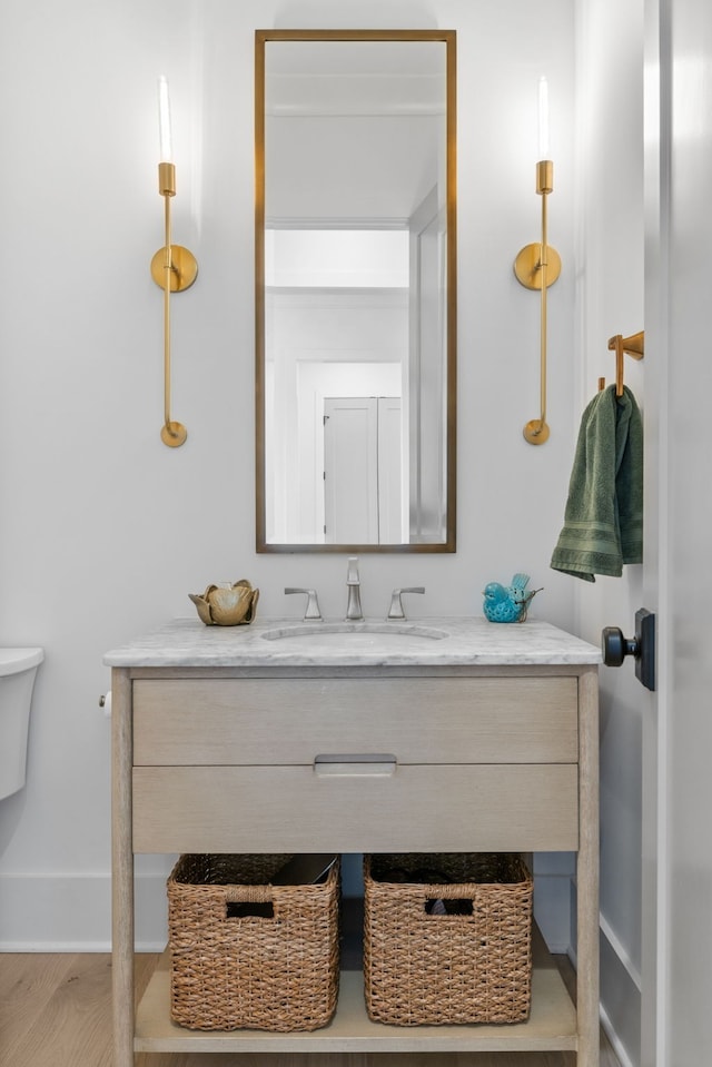 bathroom featuring vanity, hardwood / wood-style floors, and toilet