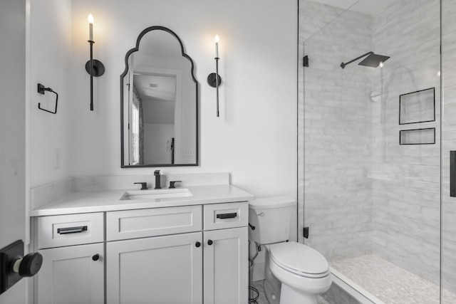 bathroom with a shower with door, toilet, and vanity