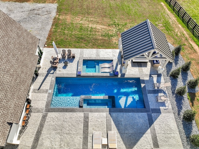 view of swimming pool with an in ground hot tub and a patio area