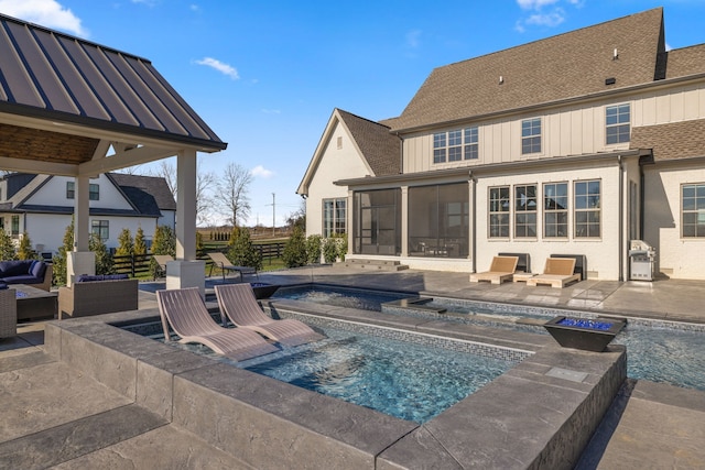 view of swimming pool with an in ground hot tub, a patio area, and an outdoor living space