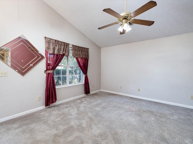 carpeted spare room featuring lofted ceiling and ceiling fan