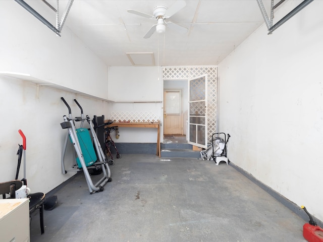 exercise room with ceiling fan and concrete floors