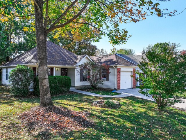 single story home with a front yard and a garage