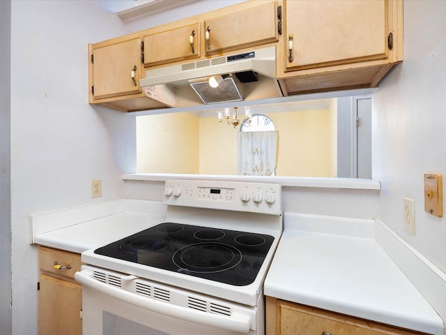 kitchen featuring a notable chandelier and white range with electric cooktop