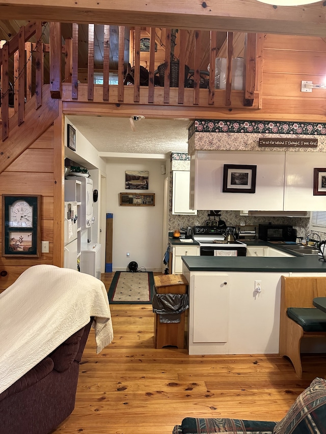 kitchen featuring decorative backsplash, light hardwood / wood-style flooring, white cabinets, and sink