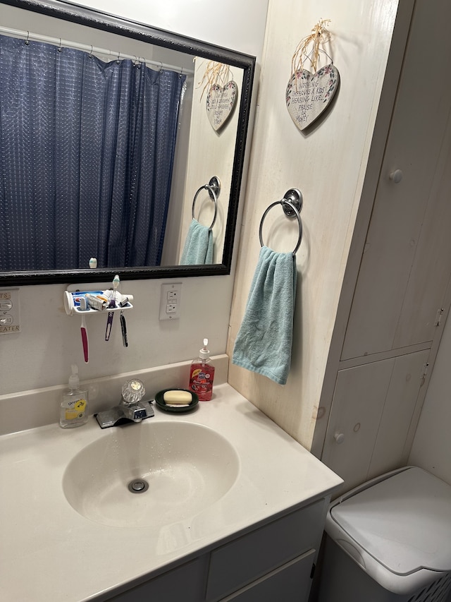 bathroom with vanity, curtained shower, and toilet