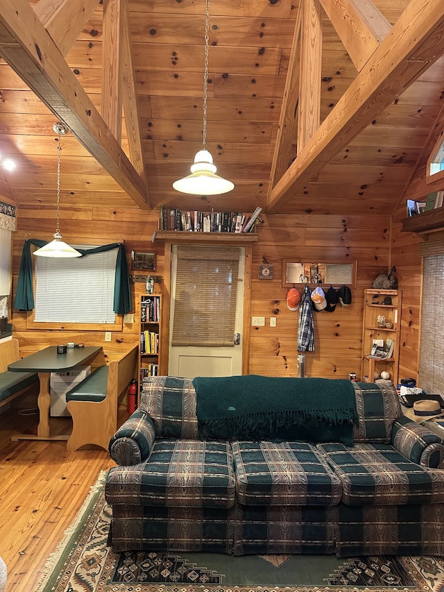 living room featuring wood walls, vaulted ceiling with beams, wood-type flooring, and wood ceiling