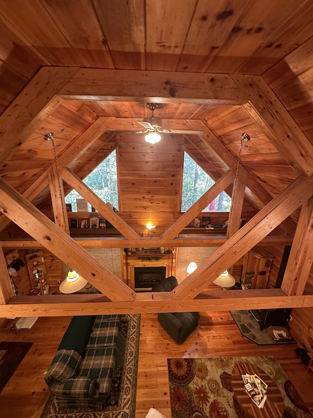 interior space with wood ceiling, wood-type flooring, a wealth of natural light, and vaulted ceiling with beams