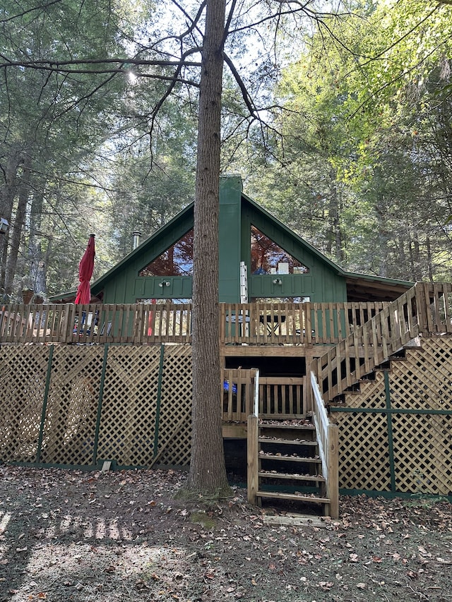 back of house featuring a wooden deck