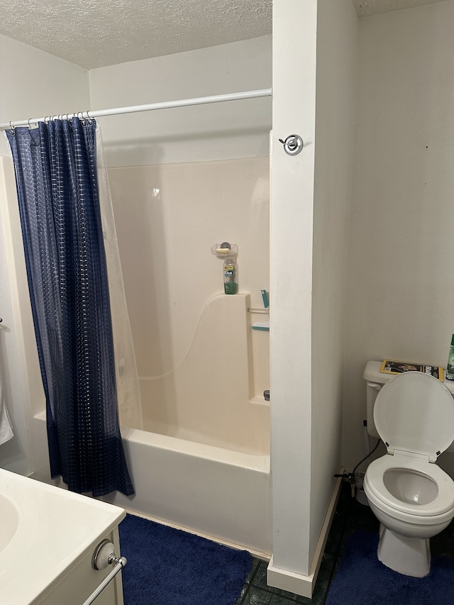 full bathroom with vanity, a textured ceiling, shower / tub combo with curtain, and toilet