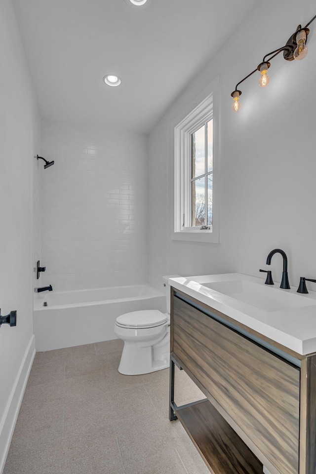 full bathroom with vanity, tiled shower / bath, tile patterned floors, and toilet