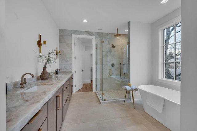 bathroom featuring vanity, plenty of natural light, and separate shower and tub