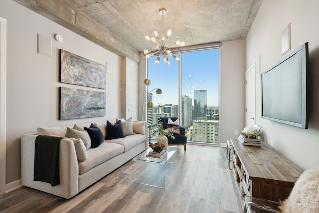 living room featuring expansive windows, a notable chandelier, and wood-type flooring